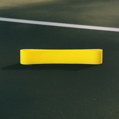 Yellow resistance band on a green tennis court