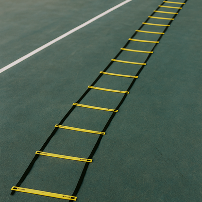 Yellow and black agility ladder on a green sports field